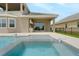 Beautiful pool and hot tub with backyard kitchen of this luxury home at 15615 Vetta Dr, Montverde, FL 34756