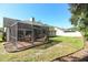 Private backyard with screened patio and grassy area at 3109 Timucua Cir, Orlando, FL 32837