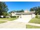 Two-car garage and attractive landscaping highlight this home's exterior at 3109 Timucua Cir, Orlando, FL 32837