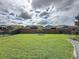 Expansive backyard with a well-maintained lawn, sturdy fencing, and serene surroundings at 518 Narrow View Ln, Groveland, FL 34736