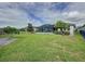 Spacious backyard with a lush green lawn, a fenced perimeter, and neatly maintained landscaping at 518 Narrow View Ln, Groveland, FL 34736