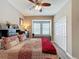 Bright bedroom featuring a ceiling fan, window seating, and ample closet space at 518 Narrow View Ln, Groveland, FL 34736