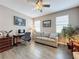 Bright bedroom with a sofa, desk, neutral color palette, and natural light at 518 Narrow View Ln, Groveland, FL 34736