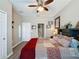 Comfortable bedroom showcasing a ceiling fan, closet, and an ensuite bathroom at 518 Narrow View Ln, Groveland, FL 34736