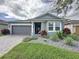 Charming single-story home with a well-manicured lawn and inviting front porch at 518 Narrow View Ln, Groveland, FL 34736
