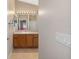 Bathroom with wood cabinets and a large mirror at 547 Richburg St, The Villages, FL 32162
