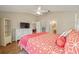 Spacious bedroom with coral bedding and built-in shelving at 547 Richburg St, The Villages, FL 32162