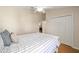 Bedroom with white bed frame and striped bedding at 547 Richburg St, The Villages, FL 32162