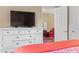 Bedroom with large TV and white dresser at 547 Richburg St, The Villages, FL 32162
