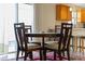Four-person dining table in the center of a well-lit room at 547 Richburg St, The Villages, FL 32162