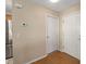 Bright entryway with light hardwood floors and two white doors at 547 Richburg St, The Villages, FL 32162