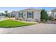 House exterior with green landscaping and a paved driveway at 547 Richburg St, The Villages, FL 32162