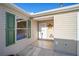 Tan house with green shutters, landscaped yard, and a paved driveway at 547 Richburg St, The Villages, FL 32162