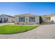 Well-maintained home with green shutters and a manicured lawn at 547 Richburg St, The Villages, FL 32162