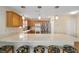 Kitchen with an island, stainless steel appliances and light wood cabinets at 547 Richburg St, The Villages, FL 32162