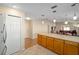 Open concept kitchen with island and views into adjacent living area at 547 Richburg St, The Villages, FL 32162