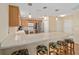 Kitchen island with seating, stainless steel appliances, and light wood cabinets at 547 Richburg St, The Villages, FL 32162