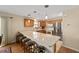 Open kitchen with breakfast bar, stainless steel appliances, and light cabinets at 547 Richburg St, The Villages, FL 32162