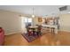 Open concept kitchen and dining area with breakfast bar and wood floors at 547 Richburg St, The Villages, FL 32162