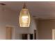 Close-up of a stylish light fixture above the kitchen island at 547 Richburg St, The Villages, FL 32162