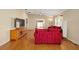 Living room with red couches and wood flooring at 547 Richburg St, The Villages, FL 32162