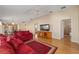 Living room with red couches and access to other rooms at 547 Richburg St, The Villages, FL 32162