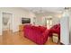 Living room with red couches and sliding glass doors at 547 Richburg St, The Villages, FL 32162