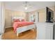 Main bedroom with king-size bed and coral bedding at 547 Richburg St, The Villages, FL 32162