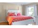 Main bedroom featuring a king-size bed with coral bedding at 547 Richburg St, The Villages, FL 32162
