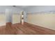 Spacious bedroom features hardwood floors, closet and beach themed paint accents at 803 Camino Del Rey Dr, The Villages, FL 32159