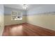 Bedroom with hard wood floors, fan, and window view of the yard at 803 Camino Del Rey Dr, The Villages, FL 32159