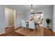 Cozy dining room with a wood table, four chairs, and natural light at 803 Camino Del Rey Dr, The Villages, FL 32159