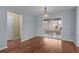 Open dining room with hardwood floors, sliding glass door and contemporary lighting at 803 Camino Del Rey Dr, The Villages, FL 32159