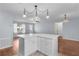 Open-concept kitchen boasts a large white center island with quartz countertop and stylish pendant lighting at 803 Camino Del Rey Dr, The Villages, FL 32159