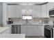 Well-lit kitchen featuring white cabinetry, modern appliances, and sleek countertops at 803 Camino Del Rey Dr, The Villages, FL 32159