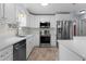 Modern kitchen with white cabinets, stainless steel appliances and tiled flooring at 803 Camino Del Rey Dr, The Villages, FL 32159