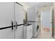 Functional laundry room with stacked washer/dryer, utility sink and abundant storage at 803 Camino Del Rey Dr, The Villages, FL 32159