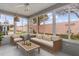 Bright sunroom with a comfortable seating area and views of the landscaped backyard at 803 Camino Del Rey Dr, The Villages, FL 32159