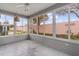 Bright sunroom with floor to ceiling windows, offering views of the landscaped yard at 803 Camino Del Rey Dr, The Villages, FL 32159