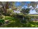 Spacious backyard with mature trees and lush greenery, offering privacy and a serene setting at 8194 Se 177Th Winterthur Loop, The Villages, FL 32162