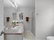 Bathroom with double sinks, updated fixtures, and a walk-in shower at 8194 Se 177Th Winterthur Loop, The Villages, FL 32162