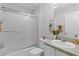 Well-lit bathroom featuring a shower-tub combo with glass doors at 8194 Se 177Th Winterthur Loop, The Villages, FL 32162