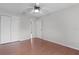 Bedroom with hardwood floors, ceiling fan, and closet space at 8194 Se 177Th Winterthur Loop, The Villages, FL 32162