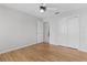 Bright bedroom with hardwood floors, ceiling fan, and closet space at 8194 Se 177Th Winterthur Loop, The Villages, FL 32162