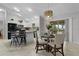 Bright dining area adjacent to kitchen with stainless steel appliances and breakfast bar at 8194 Se 177Th Winterthur Loop, The Villages, FL 32162