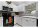 Well-lit kitchen featuring white cabinetry, modern appliances, and stylish backsplash at 8194 Se 177Th Winterthur Loop, The Villages, FL 32162