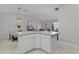 Bright kitchen with an island, white cabinets, and an open concept layout at 8194 Se 177Th Winterthur Loop, The Villages, FL 32162