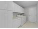 Functional laundry room with ample storage, washer, and dryer at 8194 Se 177Th Winterthur Loop, The Villages, FL 32162
