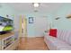 Nautical themed living room with a colorful striped sofa, ceiling fan, and light wood floors at 8194 Se 177Th Winterthur Loop, The Villages, FL 32162