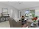 Comfortable living room with tile flooring, natural light and cozy seating at 8194 Se 177Th Winterthur Loop, The Villages, FL 32162